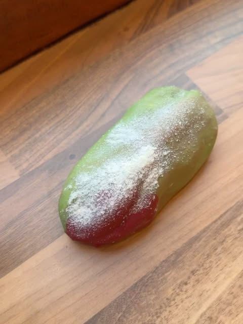Green and red glazed pastry dusted with sugar