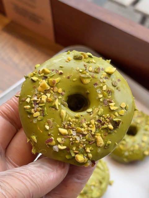 Pistachio-glazed doughnut topped with chopped pistachios